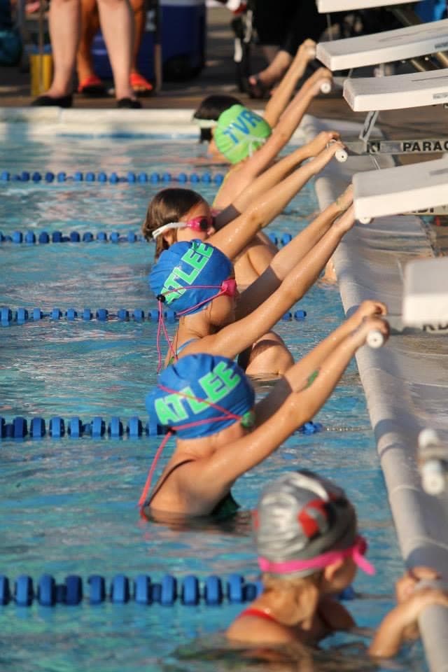Atlee Gators swim team lined up at starting blocks